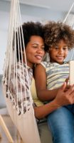 Happy african american family having fun with device at home. Black parents and child using digital tablet