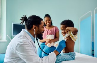Happy black kid during medical examination at doctor's office.