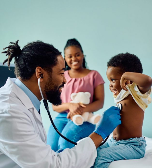 Happy black kid during medical examination at doctor's office.